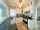 Bright kitchen features white cabinets, stainless steel appliances, and stylish backsplash, adding charm and functionality at 14124 Plum Ln, Hudson, FL 34667