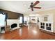 Open-concept living room featuring original hardwood floors, a fireplace, and an open view to the kitchen at 14124 Plum Ln, Hudson, FL 34667