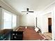 Spacious living room with hardwood floors and a modern ceiling fan at 14124 Plum Ln, Hudson, FL 34667