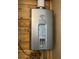 Close-up of a Rinnai tankless water heater on a wooden wall at 14124 Plum Ln, Hudson, FL 34667