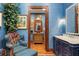 Bathroom with blue walls, marble countertop sink, and ornate wood trim at 3005 S Miller Rd, Valrico, FL 33596