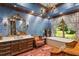 Serene bathroom featuring a vanity, large window with curtains, and a soaking tub with jets at 3005 S Miller Rd, Valrico, FL 33596
