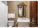 This full bathroom includes a standalone vanity and decorative mirror for a warm and stylish design at 3005 S Miller Rd, Valrico, FL 33596