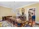 Elegant dining room with a long wood table, chandelier, and view into the kitchen at 3005 S Miller Rd, Valrico, FL 33596