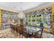 Formal dining room with pool views, chandelier, and ornate details and hardwood floors at 3005 S Miller Rd, Valrico, FL 33596