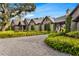 Beautiful stone home with a large driveway, manicured lawn, and gorgeous, mature landscaping at 3005 S Miller Rd, Valrico, FL 33596