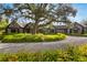 Stately home with meticulous landscaping, mature trees, and circular driveway provides an inviting curb appeal at 3005 S Miller Rd, Valrico, FL 33596