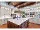 Spacious kitchen with a large center island, hardwood floors, and custom display cabinets at 3005 S Miller Rd, Valrico, FL 33596