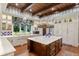 Beautiful kitchen with white cabinets, a central island, and wooden beam ceiling at 3005 S Miller Rd, Valrico, FL 33596
