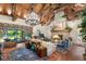 Bright living room with vaulted wood ceilings, stone fireplace, and floor-to-ceiling windows at 3005 S Miller Rd, Valrico, FL 33596