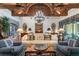 Inviting living room with wood beam ceiling, stone accents, and comfortable seating arrangements at 3005 S Miller Rd, Valrico, FL 33596