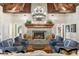 Spacious living room featuring a stone fireplace, wood beamed ceilings, and plush seating at 3005 S Miller Rd, Valrico, FL 33596