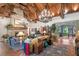 Expansive living room features a stone fireplace, wood ceilings, and access to other rooms at 3005 S Miller Rd, Valrico, FL 33596