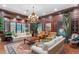 Inviting living room with wood paneling, comfortable seating, and a decorative chandelier at 3005 S Miller Rd, Valrico, FL 33596