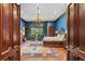 Spacious bedroom with an ornate chandelier, wood floors, sitting area and a large area rug at 3005 S Miller Rd, Valrico, FL 33596