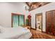 A spacious main bedroom offers a peaceful retreat with wood ceilings, hardwood floors, and private ensuite at 3005 S Miller Rd, Valrico, FL 33596