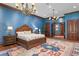 Elegant bedroom with wood trim, chandelier, area rug and bed with patterned linens at 3005 S Miller Rd, Valrico, FL 33596