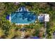 Aerial view of a pristine pool area, complete with lush landscaping, and comfortable lounge seating at 3005 S Miller Rd, Valrico, FL 33596