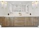 Modern bathroom featuring a double vanity with marble countertop and luxury bronze fixtures at 531 Danube Ave, Tampa, FL 33606