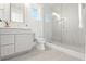 Bathroom featuring a sleek glass shower, gray vanity with modern fixtures and gray tile flooring at 531 Danube Ave, Tampa, FL 33606