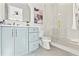 Bright bathroom features a modern vanity, toilet, and glass-enclosed shower with gold hardware and hexagon tile flooring at 531 Danube Ave, Tampa, FL 33606