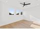 Bright bedroom with hardwood floors, white walls and three large windows providing ample natural light at 531 Danube Ave, Tampa, FL 33606