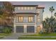 Modern two-story home featuring a sleek design, balcony, and two-car garage, perfect for contemporary living at 531 Danube Ave, Tampa, FL 33606