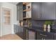 Kitchenette features custom black cabinets, brass hardware, and beverage center at 531 Danube Ave, Tampa, FL 33606