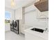 Modern laundry room with stainless steel washer and dryer, white cabinets, quartz countertops and a sink at 531 Danube Ave, Tampa, FL 33606
