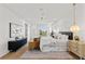 Bright main bedroom with hardwood floors, white walls, modern furniture, and a stylish ceiling fan at 531 Danube Ave, Tampa, FL 33606