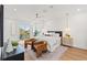 Bright main bedroom with hardwood floors, a ceiling fan, and a sliding glass door with balcony access at 531 Danube Ave, Tampa, FL 33606