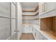 Bright walk-in pantry boasts custom white cabinets and wood shelving with convenient access at 531 Danube Ave, Tampa, FL 33606