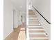 Open staircase with hardwood treads, modern railing, and abundant natural light at 531 Danube Ave, Tampa, FL 33606