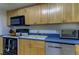 A functional kitchen design with blue countertops and white appliances at 5396 Gulf Blvd # 110, St Pete Beach, FL 33706