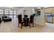 An open concept space with a living room and dining area leading to a kitchen with light-colored cabinets at 5396 Gulf Blvd # 110, St Pete Beach, FL 33706