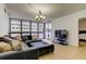 Comfortable living room with tiled floor, large sectional sofa, and lots of light from the large window at 5396 Gulf Blvd # 110, St Pete Beach, FL 33706