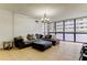 Cozy living room with large sectional sofa, tiled floor, and bright light at 5396 Gulf Blvd # 110, St Pete Beach, FL 33706
