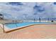 A picturesque swimming pool with lounge chairs and umbrellas overlooking a white sandy beach and ocean at 5396 Gulf Blvd # 110, St Pete Beach, FL 33706