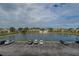 A scenic aerial view of the community's central lake with palm trees and condo building parking at 6400 46Th N Ave # 307, Kenneth City, FL 33709
