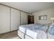 Bedroom with wood-look floors, closet with sliding doors, and a bed with patterned bedding at 6400 46Th N Ave # 307, Kenneth City, FL 33709