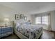 Bright bedroom with decorative art and a bed with patterned seashell bedding at 6400 46Th N Ave # 307, Kenneth City, FL 33709