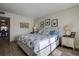 Bright bedroom with marine life decor, and an ensuite bathroom beyond doorway at 6400 46Th N Ave # 307, Kenneth City, FL 33709