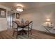 Cozy dining area with a chandelier, a round wooden table, and stylish chairs at 6400 46Th N Ave # 307, Kenneth City, FL 33709