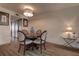 Dining room with round table and wood flooring, lit by modern chandelier at 6400 46Th N Ave # 307, Kenneth City, FL 33709