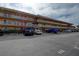 Three-story condo building featuring balconies, multiple parking spaces and well-maintained landscaping at 6400 46Th N Ave # 307, Kenneth City, FL 33709