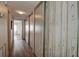Hallway featuring vinyl floors and a wall of closet doors with white paneling at 6400 46Th N Ave # 307, Kenneth City, FL 33709
