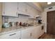 A well-maintained kitchen with white cabinets, countertops and modern appliances at 6400 46Th N Ave # 307, Kenneth City, FL 33709