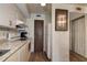 Kitchen featuring updated countertops and appliances, as well as a door to the hallway at 6400 46Th N Ave # 307, Kenneth City, FL 33709