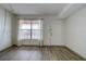 Bright living room showcasing new floors, a window, and a white front door at 6400 46Th N Ave # 307, Kenneth City, FL 33709