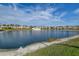 Scenic view of the neighborhood pond surrounded by grass and palm trees at 6400 46Th N Ave # 307, Kenneth City, FL 33709